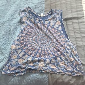 A tie dyish shirt open cuts on the side.